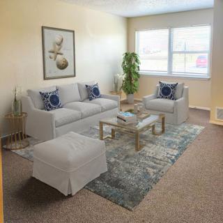 A cozy and stylish living room with modern furnishings and a touch of greenery.