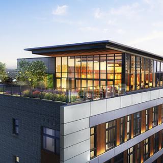 A modern rooftop design showcasing expansive glass windows and an inviting outdoor area.