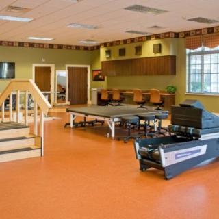 A cozy indoor bowling alley with a warm ambiance, featuring wooden lanes and seating area.