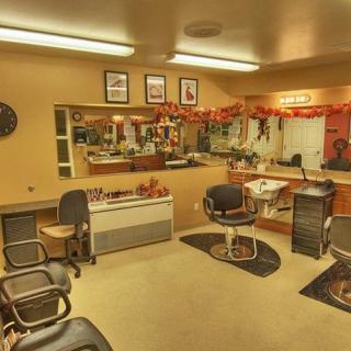 A cozy and decorated barbershop interior with chairs and mirrors.