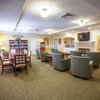 A cozy living room with comfortable seating, a dining table, and a fireplace, creating a welcoming atmosphere.