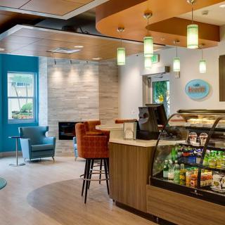 A modern cafe with a snack display and comfortable seating area.