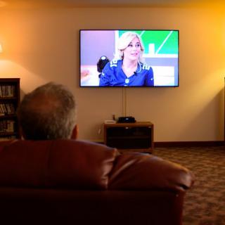 A person watching a show on television in a cozy living room.