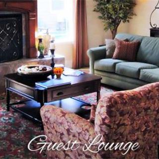 A cozy guest lounge with comfortable seating and elegant decor.