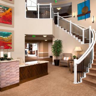 A modern lobby with a grand staircase and contemporary artwork.