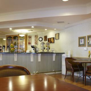 A cozy cafe interior with a seating area and counter.