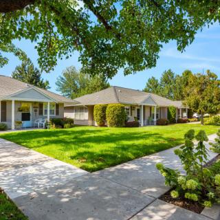 A sunny view of a residential area with well-maintained lawns and pathways.