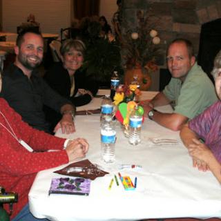 A group of friends enjoying a meal together at a restaurant.