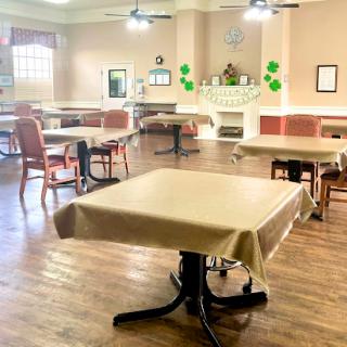 A spacious dining area with neatly arranged tables and chairs, ready for guests.