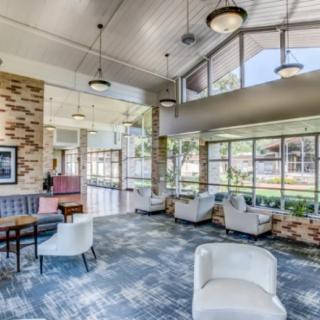 Modern lobby interior with ample natural light and stylish furniture.
