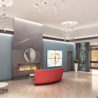 A modern lobby with a fireplace, contemporary lighting, and comfortable seating.