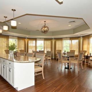 A modern dining area with elegant lighting and abundant natural light.