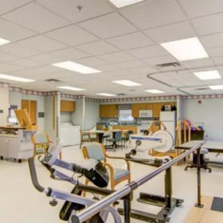A well-equipped rehabilitation facility with exercise equipment and medical amenities.