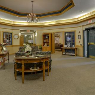 An elegantly decorated lobby with comfortable seating and a chandelier.