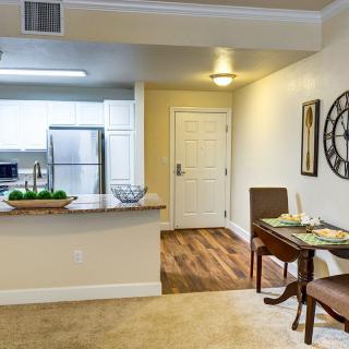 A modern apartment interior featuring a kitchen and dining area with contemporary decor.