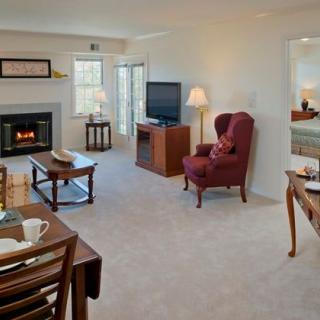 A cozy living room with a fireplace, television, and comfortable seating.