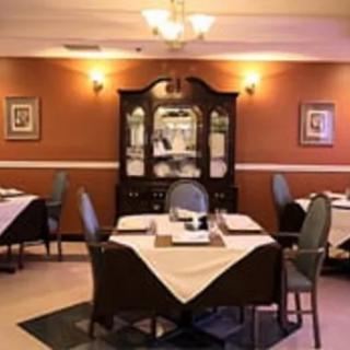 Elegantly set tables in a cozy restaurant dining room.