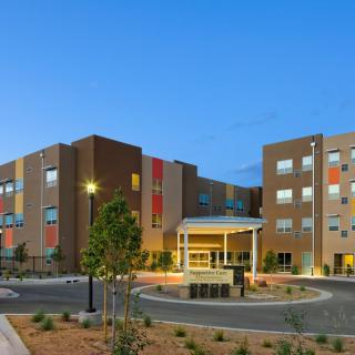 A modern commercial building with contemporary design features, illuminated at dusk.