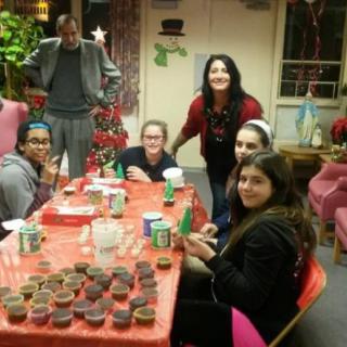 A group of people gathered around a table for a holiday celebration.