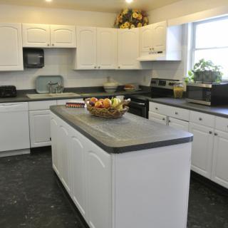 A modern kitchen with white cabinets and a central island.