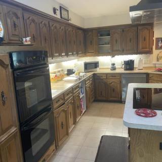A cozy kitchen with wooden cabinets and modern appliances.