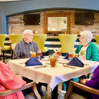 A group of seniors enjoying a meal together at a restaurant.