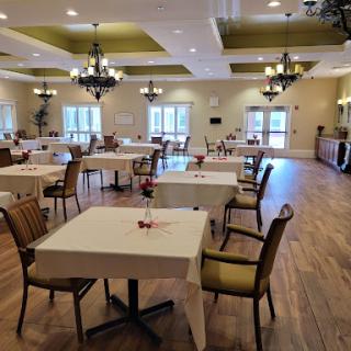 A spacious and elegantly decorated dining area with tables set for guests.
