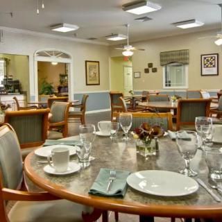 An elegantly set dining table in a spacious restaurant interior.