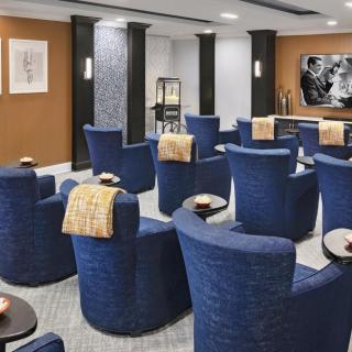A modern seating area with blue chairs arranged in a conference style.