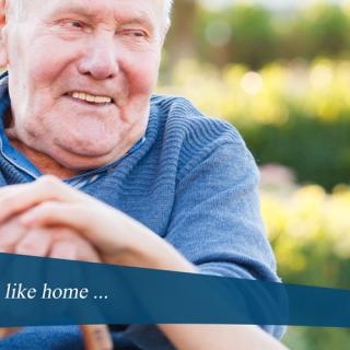 An elderly man enjoying a peaceful moment outdoors.