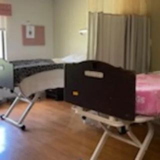 A hospital room with two medical beds.
