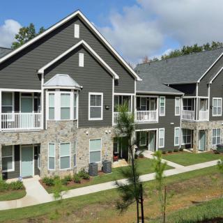 Modern apartment complex with a landscaped exterior.