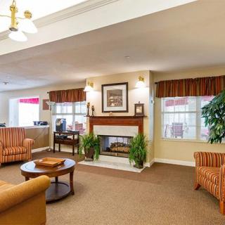A cozy living room with comfortable seating and a fireplace.