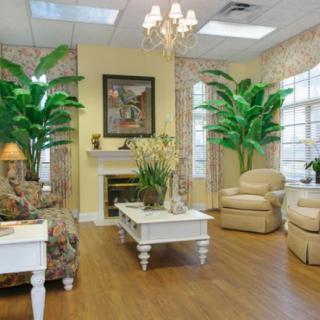 A cozy living room with elegant furniture and lush green plants.