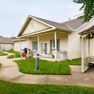 A cozy residential house with a well-maintained lawn and porch.
