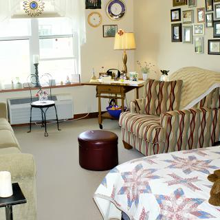 A cozy living room with comfortable seating and decorative wall art.