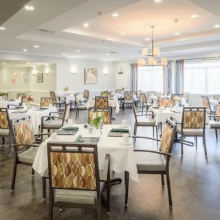 An elegant dining room with neatly arranged tables and chairs, showcasing tasteful interior design.