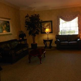 Cozy living room with sofas, a coffee table, and warm lighting.