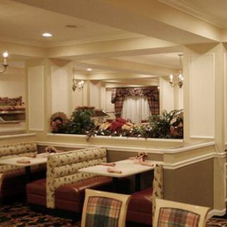 A cozy restaurant interior featuring booth seating and classic decor.