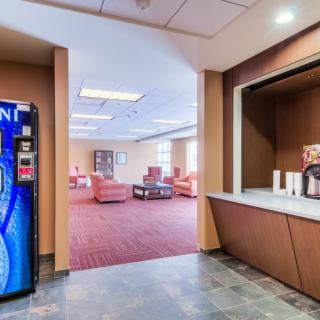 A lobby area with a vending machine and comfortable seating.