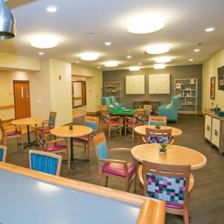 A colorful communal space with tables and chairs, ideal for gathering or activities.