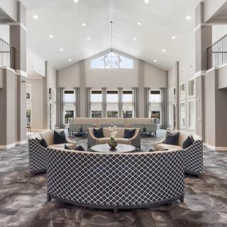 A modern lobby with stylish seating and a high ceiling.