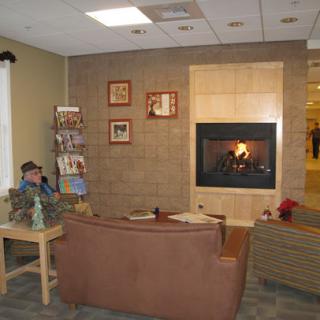 A cozy lounge area with a fireplace and comfortable seating.