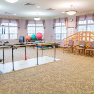 A rehabilitation room equipped with physical therapy tools and exercise equipment.