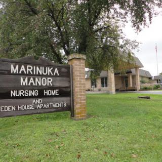 Marinuka Manor Nursing Home and Eden House Apartments signage in front of the facility.