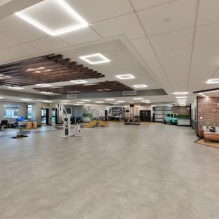A spacious and modern interior design featuring a lobby area with sleek flooring and contemporary lighting.