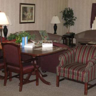 A cozy living room with comfortable seating and elegant lighting.