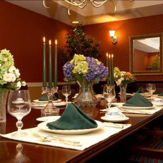 An elegantly set dining table with candles and floral arrangements.