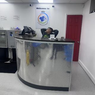 A reception area with a staff member relaxing at the counter.