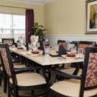 A well-decorated dining room with a large table and chairs.